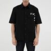Camisa de pantalón corto de algodón estampada en color liso, negra