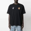 Camiseta de manga corta con estampado de manzana y flecha, corte holgado, negro