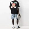 Camiseta de manga corta con estampado de manzana y flecha, corte holgado, negro