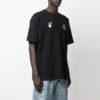 Camiseta de manga corta con estampado de manzana y flecha, corte holgado, negro