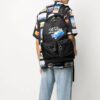 Mochila escolar de estilo industrial con 20 logotipos, eslóganes y letras impresas y múltiples bolsillos
