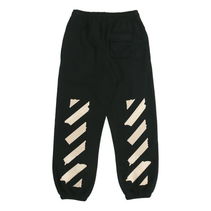 Pantalones deportivos negros con rayas y correa de goma en negro y dorado
