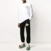 Pantalones deportivos negros con rayas y correa de goma en negro y dorado