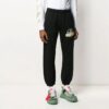 Pantalones deportivos negros con rayas y correa de goma en negro y dorado