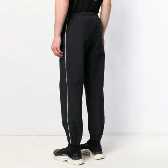 Pantalones informales de hombre Off-White de color liso con raya lateral blanca, negros