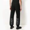 Pantalones largos deportivos con estampado de flechas, negros